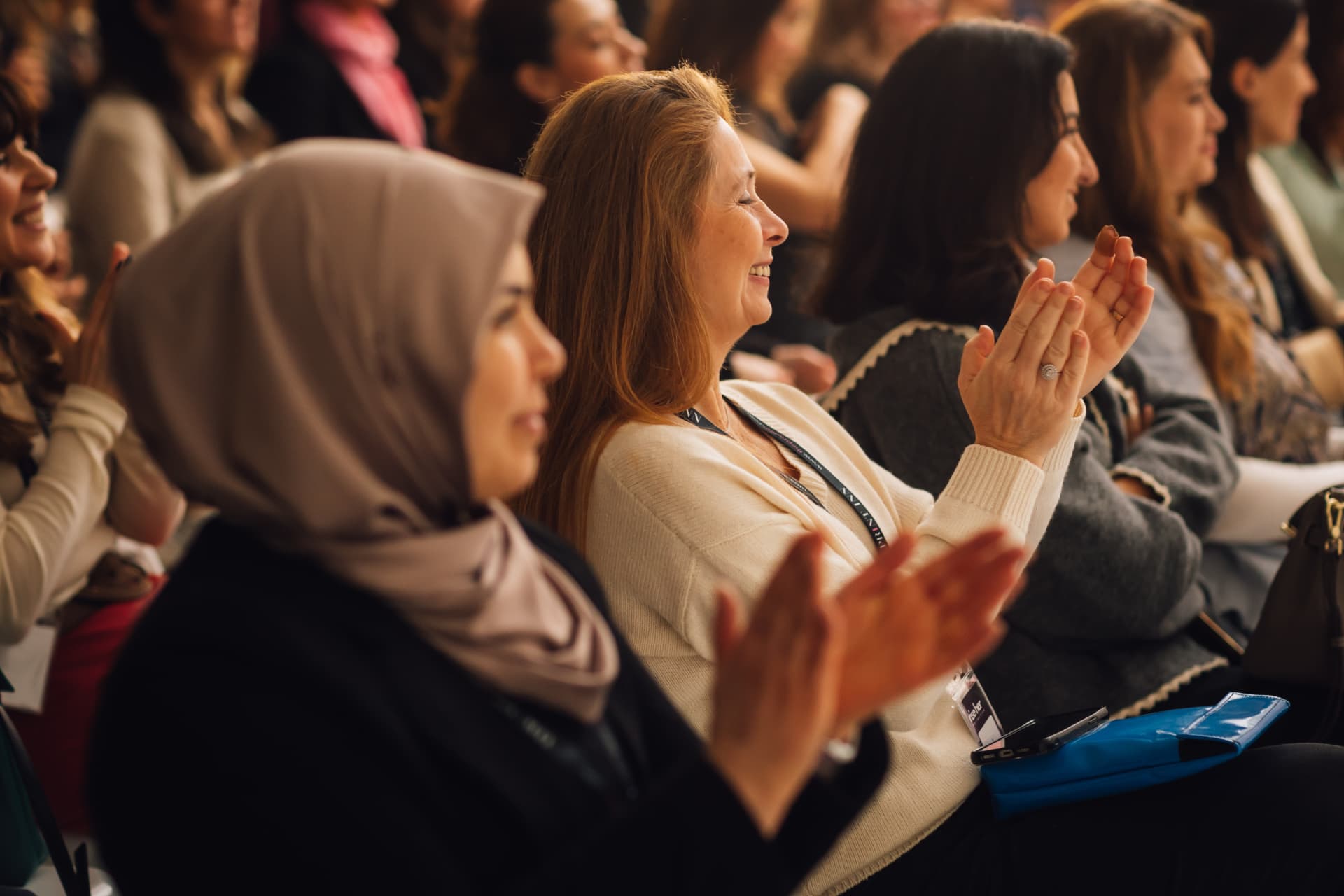 Rise Her Collective audience applauding at an event